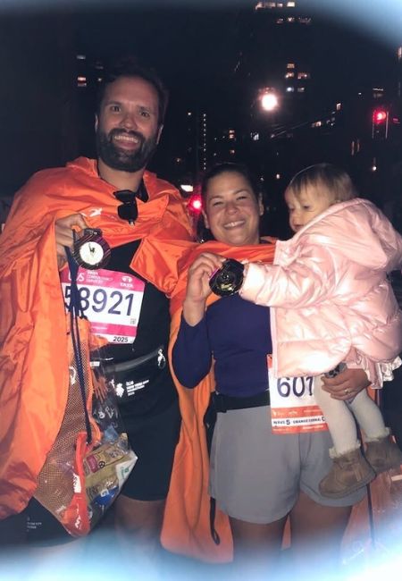 Sissy and me holding our medals after crossing the finish line at the 2025 NYC Marathon