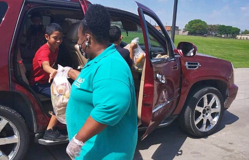 school support staff feeding children