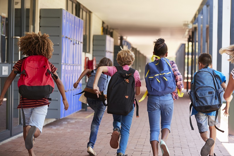 Students running towards summer break